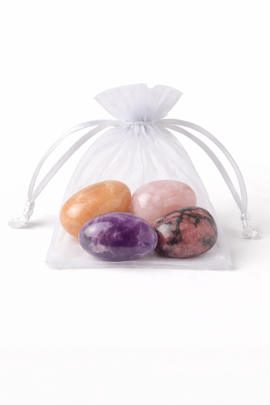 Set of colorful stones in a white drawstring bag on a white background
