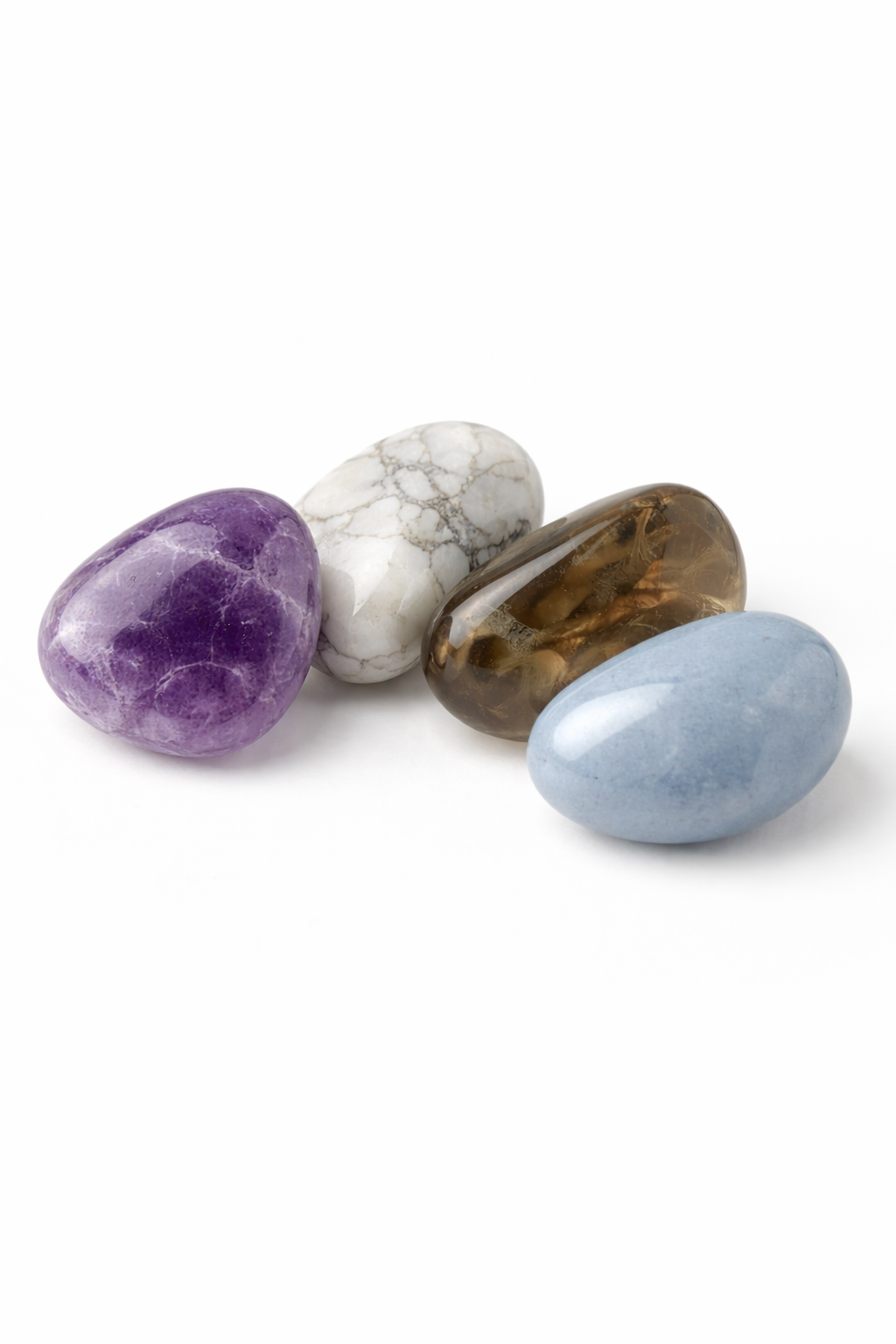 Four different colored stones on a white background