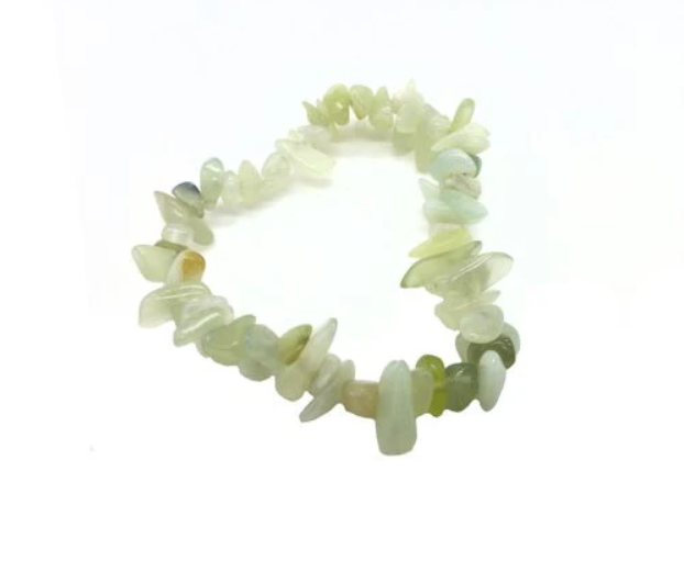 Neon green bracelet with chip stones on a white background