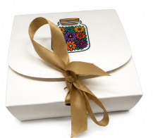 White gift box with a gold ribbon and colorful label on a white background