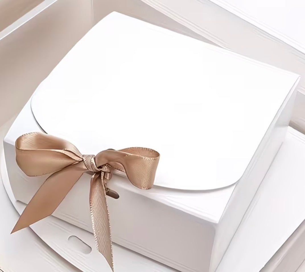 White box with a gold ribbon on a white background