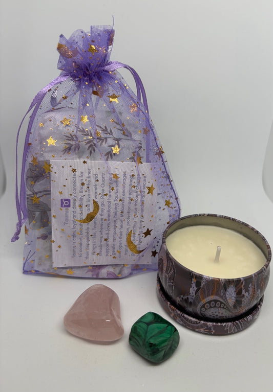 Purple organza gift bag with a rose quartz crystal and malachite crystal with a soy wax candle in a tin
