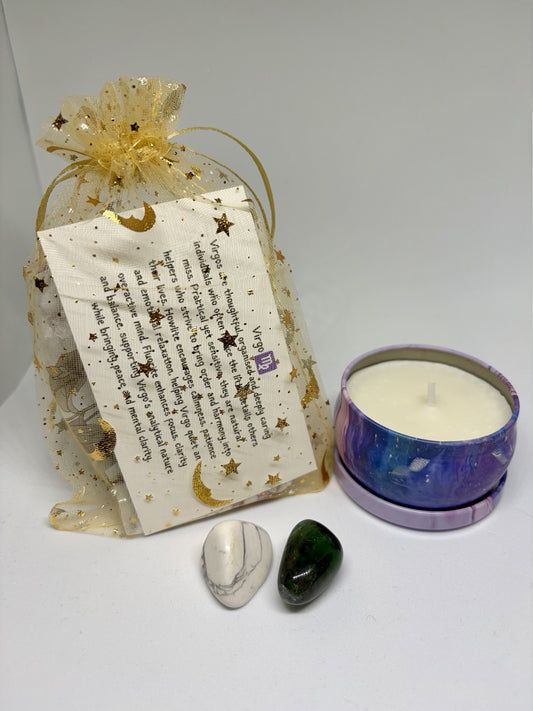 Decorative gift bag with a card, two stones, and a candle on a white background