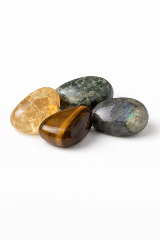 Four different colored gemstones on a white background