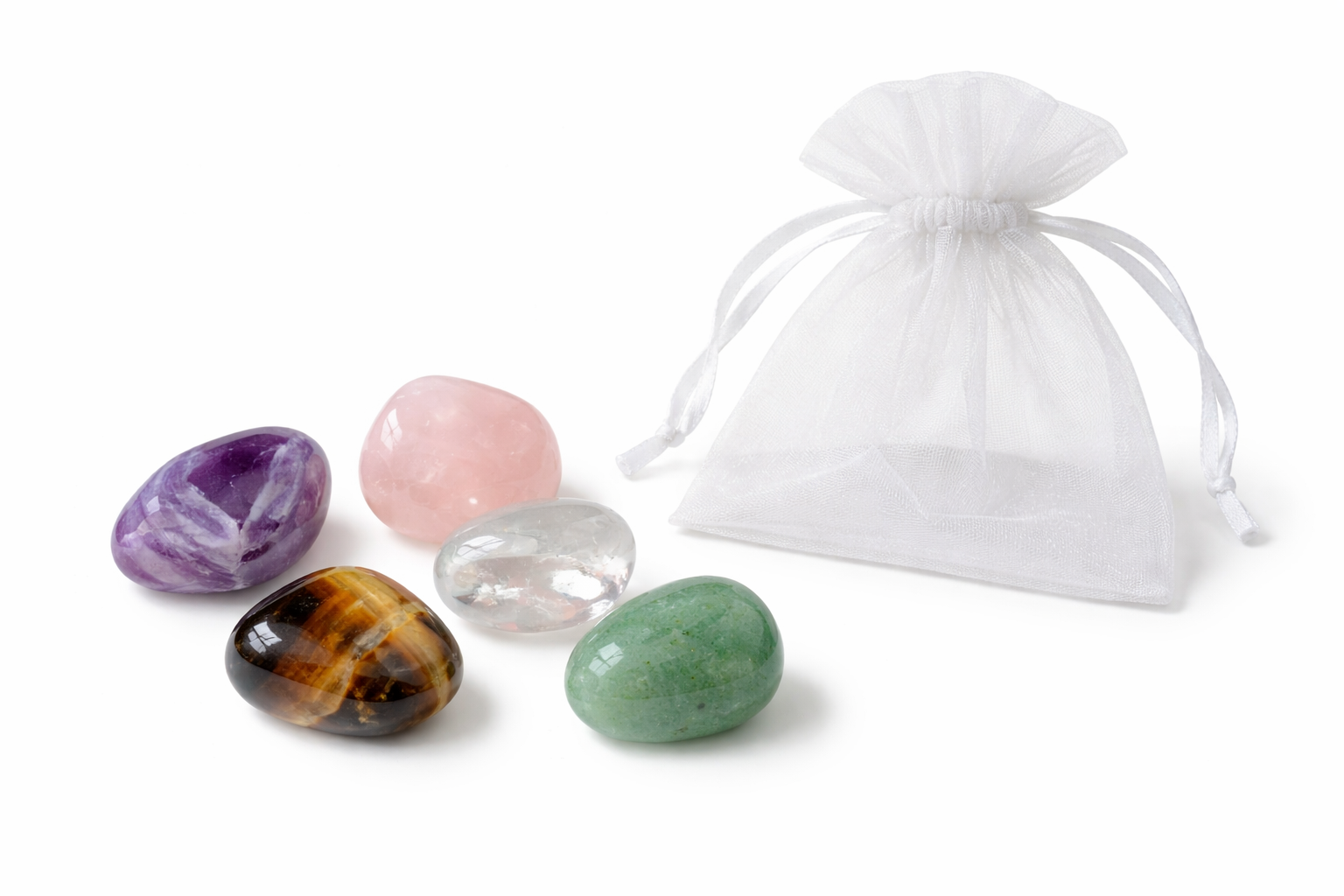 Set of four colorful crystals with a white drawstring bag on a white background