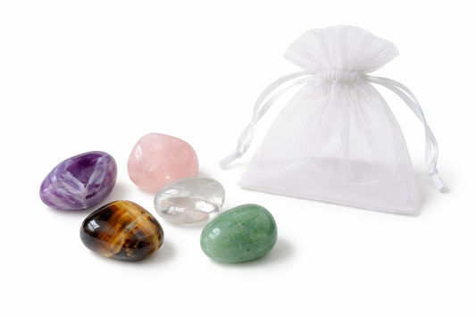 Set of four colorful crystals with a white drawstring bag on a white background